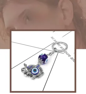 Detailed view of silver elephant keychain with blue evil eye and sparkling rhinestones
