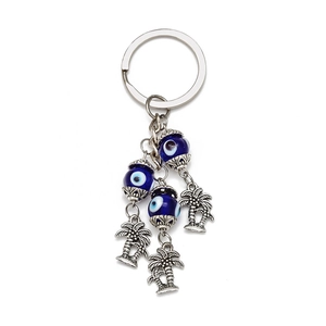 Evil Eye and Palm Tree keychain with three dark blue glass beads and silver pendants