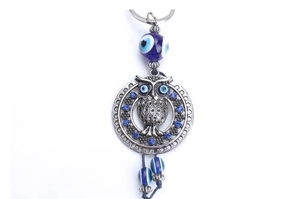 Detail of owl keychain with blue evil eye beads and rhinestones in vintage silver