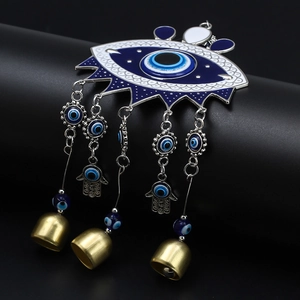 Detail of Hamsa Hand and Evil Eye hanging ornament with blue beads and small metal bells