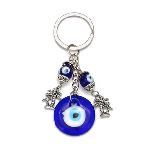 Blue evil eye keychain with silver coconut tree charms and glass bead pendants