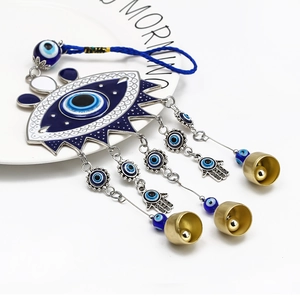 Blue evil eye wall hanging with hamsa hand metal charm and golden bell wind chimes