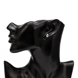 Side view of a golden heart-shaped Evil Eye stud earring worn on a black model bust