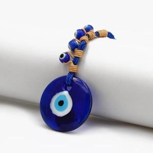 Detailed view of the woven blue evil eye lucky charm with glass beads and braided cord