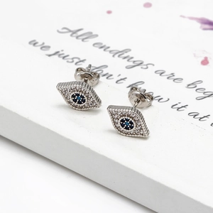 Macro shot of S925 sterling silver evil eye stud earring with blue zircon stone inlay