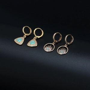 Macro shot of gold Evil Eye hoop earrings with micro-pave cubic zirconia crystals