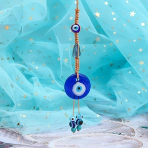 Detail of Turkish Evil Eye hanging ornament with hand-woven rope and blue glass beads