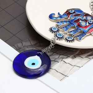 Detailed close-up of a blue enamel elephant keychain with evil eye glass pendant charms