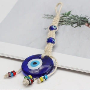 Handmade Evil Eye wall hanging with blue glass and macrame for home office decor