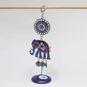Detail of silver elephant keychain featuring blue nazar evil eye charms and enamel accents