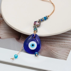 Turkish blue evil eye wall hanging charm with decorative beads on a rope for home decor
