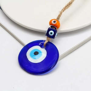 Turkish Evil Eye hanging ornament with blue glass pendant and woven hemp rope cord