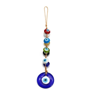 Macro detail of handmade Turkish evil eye charm with colorful glass beads on white backdrop