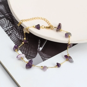 Detailed view of gold chain bracelet with purple gravel stones and adjustable clasp