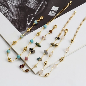 Detail of colorful irregular natural stone bracelets with golden beads and lobster clasp