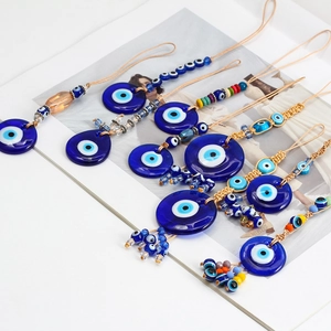 Detailed close-up of blue glass evil eye charms with intricate woven cords and beads