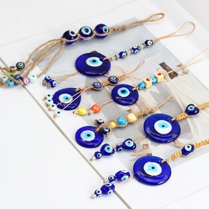 Macro view of blue glass Evil Eye pendants with woven rope and decorative heart beads