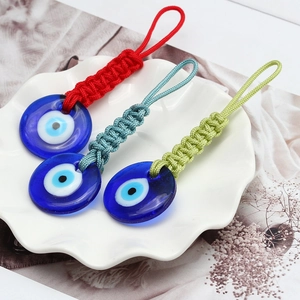 Handmade woven rope Turkish Evil Eye keychain charms in vibrant red blue and green colors