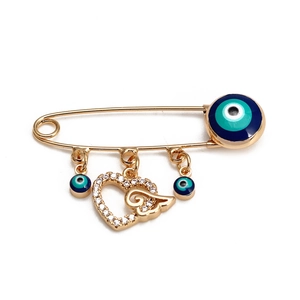 Broche épingle dorée avec œil porte-bonheur bleu et pendentif cœur en cristal