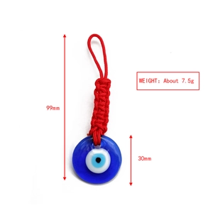 Detail view of woven red rope and Evil Eye glass pendant with dimensions 99mm and 30mm