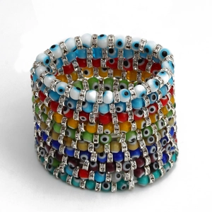 Detailed macro view of colorful evil eye beads and sparkling rhinestone spacers on bracelets