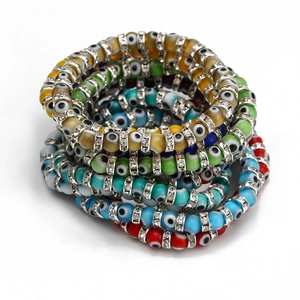 Close-up of bohemian evil eye beaded bracelets with colorful resin beads and rhinestones