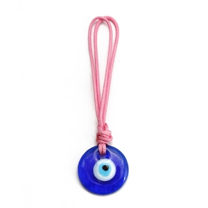 Detail of blue glass Evil Eye pendant with pink woven cord on a clean white background