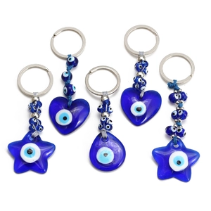 Five-piece blue evil eye keychain set with heart and star charms on a white background