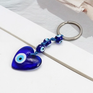 Detail of blue glass heart Evil Eye keychain with woven cord and silver ring