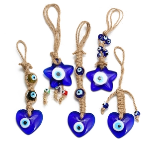 Blue glass evil eye keychains with heart and star pendants on natural jute ropes