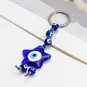 Blue star-shaped Evil Eye keychain pendant with glass beads and silver ring detail