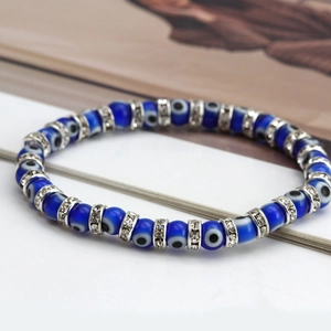 Detail of blue evil eye beads with crystal-encrusted silver spacers on an elegant bracelet