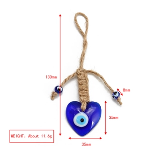 Detailed view of blue heart-shaped Evil Eye glass pendant with woven hemp rope dimensions