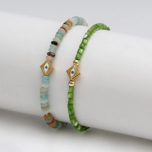 Ethnic style Evil Eye beaded bracelet set with natural stones on a white jewelry stand