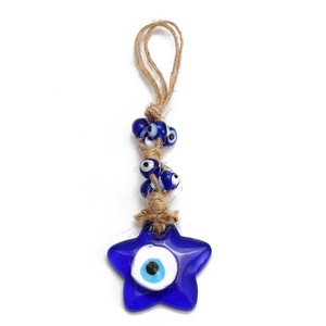 Detail of star-shaped evil eye pendant with blue glass beads and rustic hemp rope