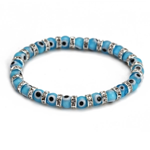 Detailed macro view of light blue evil eye beads with silver crystal spacer beads