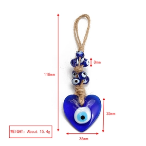 Close-up of heart-shaped Turkish Evil Eye charm with precise dimensions and hemp rope cord