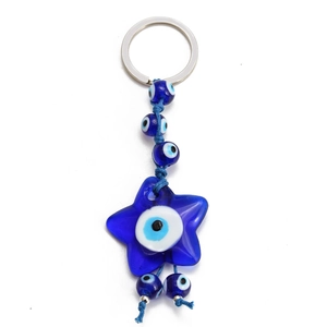 Macro detail of blue evil eye star keychain with braided rope and resin beads