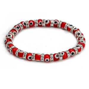 Close-up of red Turkish Evil Eye bracelet with silver rhinestone spacers on white background