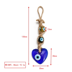 Detailed view showing dimensions of Evil Eye woven charm with glass heart pendant