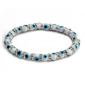Close-up of blue evil eye beaded bracelet with silver rhinestone spacers on white base