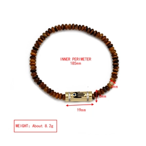 Detail view of Evil Eye beaded bracelet with Hamsa Hand charm and 4mm tiger eye stones