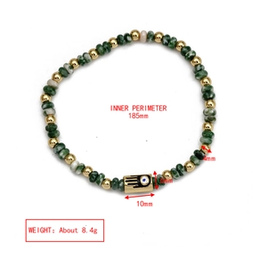 Detail view of Evil Eye beaded bracelet with 4mm green stone beads and gold Hamsa pendant