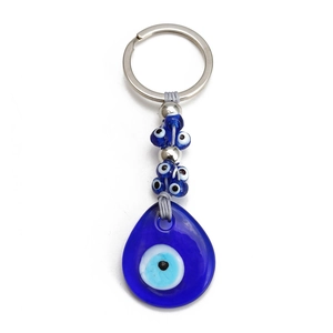 Detail of blue evil eye keychain featuring glass beads and a large teardrop charm