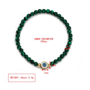 Detail view of 4mm green agate evil eye beaded bracelet with exact size and weight specs