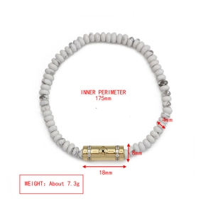 Detail showing 4mm white stone beads and gold evil eye tube bead with dimensions