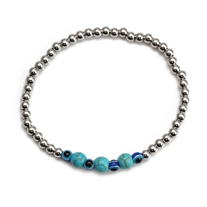 Detail of beaded evil eye bracelet with silver spheres and turquoise stones