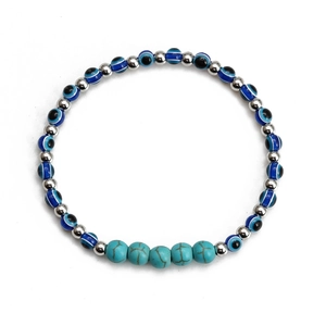 Detail shot of Evil Eye beads with turquoise accents and silver spacers on the bracelet