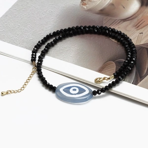 Exotic evil eye necklace with black faceted beads and gold lobster clasp jewelry