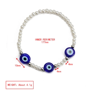 Detail showing blue evil eye beads with white pearls and silver spacers for size reference